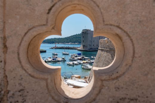 View of Dubrovnik Old Town harbour through a stone window